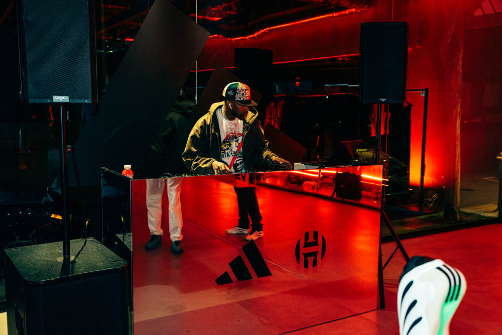 Adidas Harden Vol. 9 event - DJ at console with red lighting
